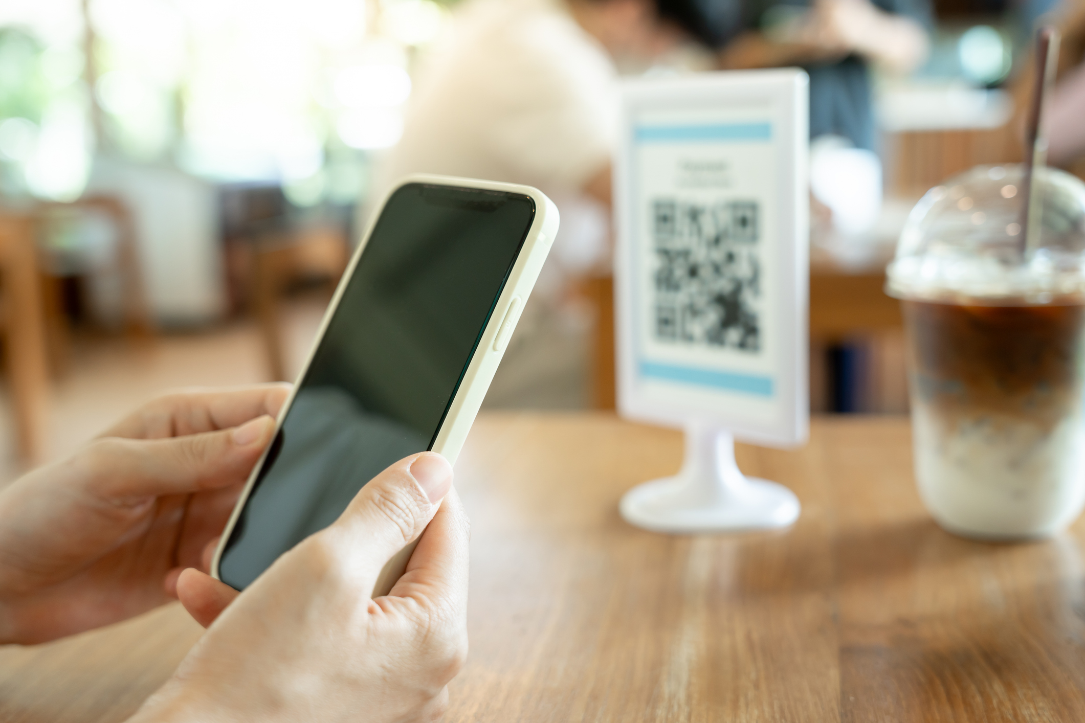 Woman use smartphone to scan QR code for order menu in cafe restaurant with a digital delivery. Choose menu and order accumulate discount. E wallet, technology, pay online, credit card, bank app.